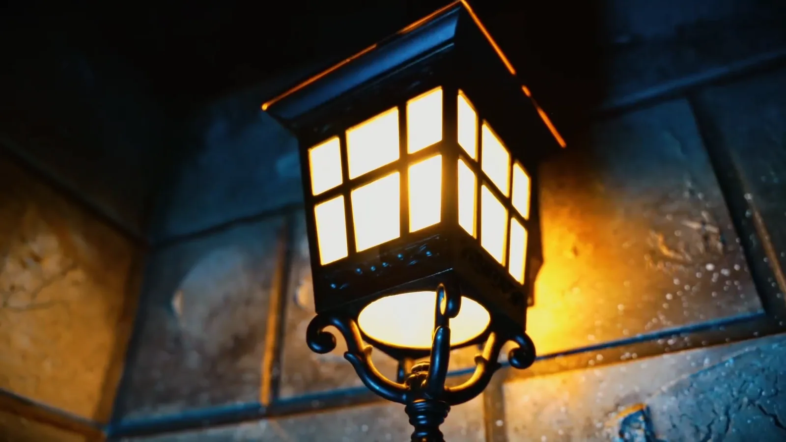 An iron lantern glowing against the stone walls of The Wizard's Chamber